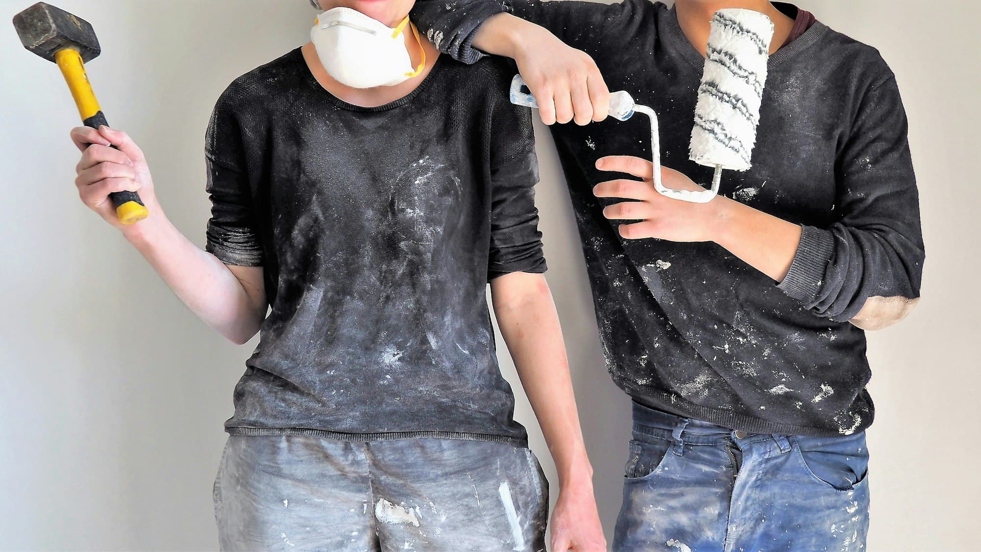 Two RS Professional painters with a sledgehammer and paint roller, ready to start a job